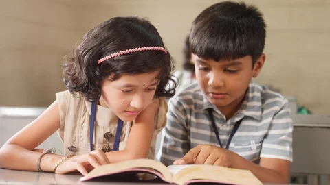 Kids reading book together