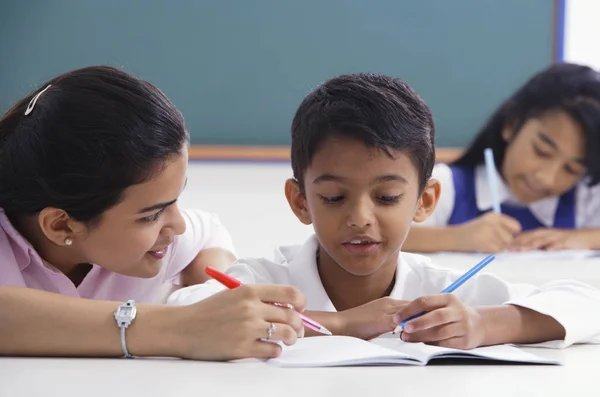 Teacher helping student with schoolwork